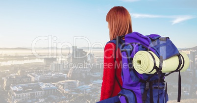 Female tourist with backpack and sleeping mat against cityscape