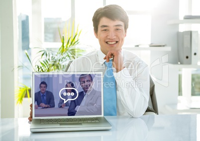 Portrait of smiling businessman showing laptop with video calling screen