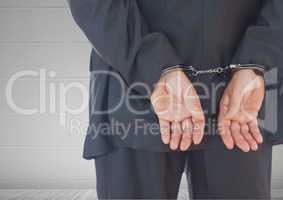 Businessman hands in handcuffs
