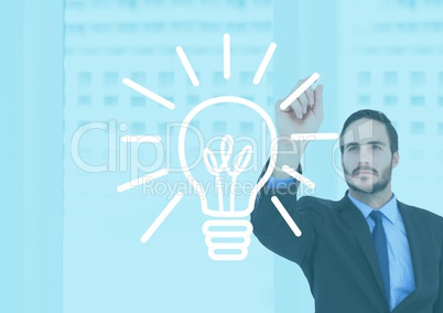 Businessman drawing electric bulb against office building background
