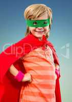 Portrait of smiling super kid in red cape and green mask