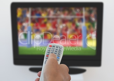 Man using remote control to change channels
