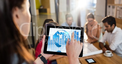 Woman using digital tablet in office