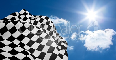 Checkered flag waving against lens flare