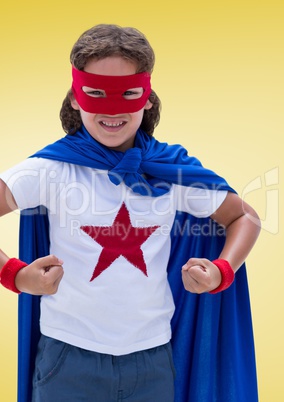 Kid pretending to be a superhero against yellow background