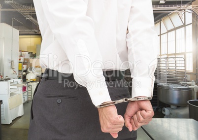Businessman hands in handcuffs
