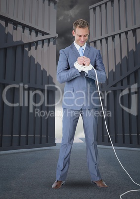Digital composite image of businessman with hands tied up