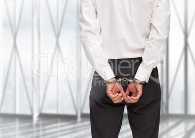 Rear view of guilty businessman with his hands cuffed
