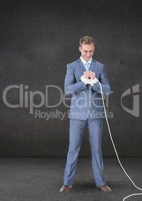 Businessman hands tied with a rope against grey background