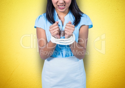 Mid section of angry businesswoman being tied up with rope