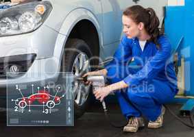 Female mechanic working against car mechanics interface in background