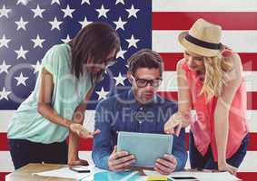 Friends using digital tablet against american flag in background