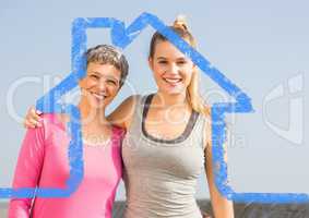 Mother and daughter standing outdoors against house outline in background
