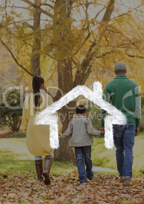 Family walking in the woods against house outline in background