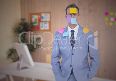 Businessman with sticky notes stuck on his face