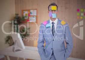 Businessman with sticky notes stuck on his face