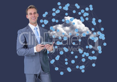 Portrait of businessman using digital tablet against connecting icons on clouds
