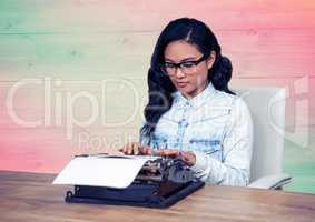 Woman in spectacles using typewriter in the office