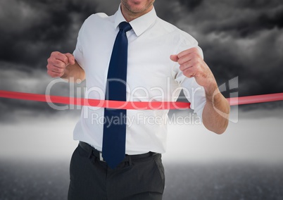 Excited businessman crossing the finish line