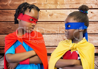Kids in superhero costume standing with arms crossed
