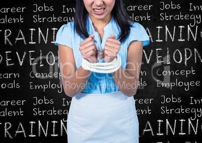 Businesswoman tied up with rope against blackboard