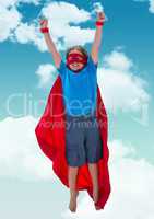 Kid pretending to be superhero against sky in background