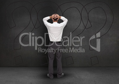 Frustrated businessman with his hands on his head against black background