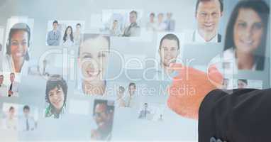 Hand touching profile pictures of business executives