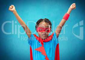 Smiling boy wearing superhero costume standing with arms outstretched