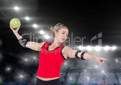 Athlete playing handball against stadium in background