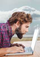 Man using laptop against grey background