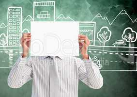 Businessman holding blank placard in front of his face against hand drawn office buildings in backgr