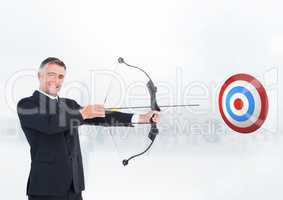 Businessman aiming at the target board against white background
