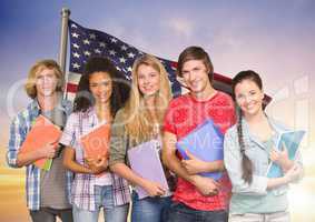 Friends with books standing against american flag in background