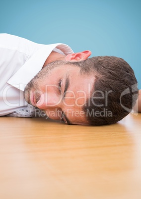 Man resting his head on desk