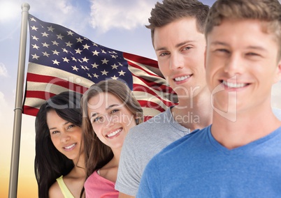 Portrait of happy teenagers standing against American flag