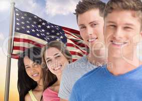 Portrait of happy teenagers standing against American flag