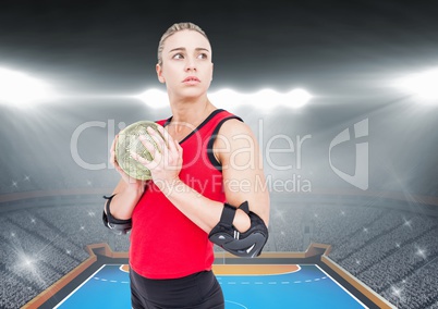 Determined player holding a handball in stadium