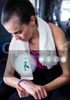 Woman checking her fitness band in gym