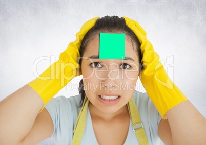 Worried female cleaner with sticky note on her forehead
