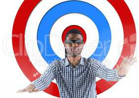 Conceptual image of male executive with black band on eyes against standing archery board