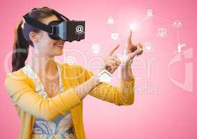 Woman using virtual reality headset with digitally generated icons