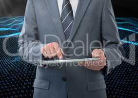Businessman using digital tablet against binary code interface in background