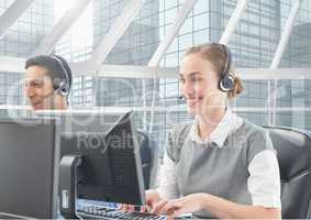 Man and woman talking on headset in customer service office