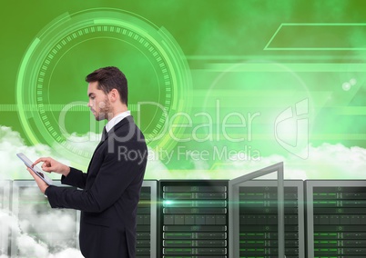 Businessman using digital tablet against server room