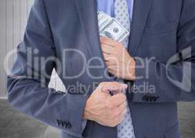 Businessman holding fanned out currency in corridor