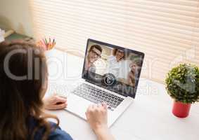 Woman having video call with friends on laptop