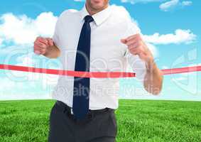 Businessman crossing finish line against sky and cloud