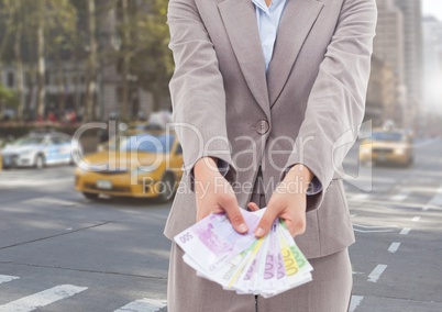 Businesswoman holding euro banknotes