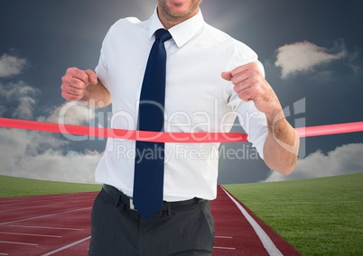 Digital composite image of a businessman winning the race